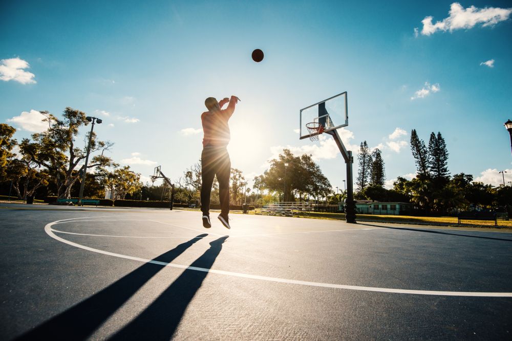 Man shooting basketball on the court in USA in summer - Atlantic ...