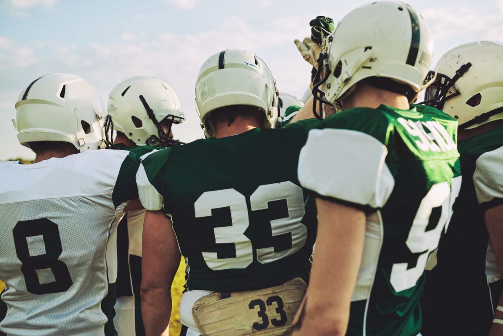 American football team huddling together before a big game